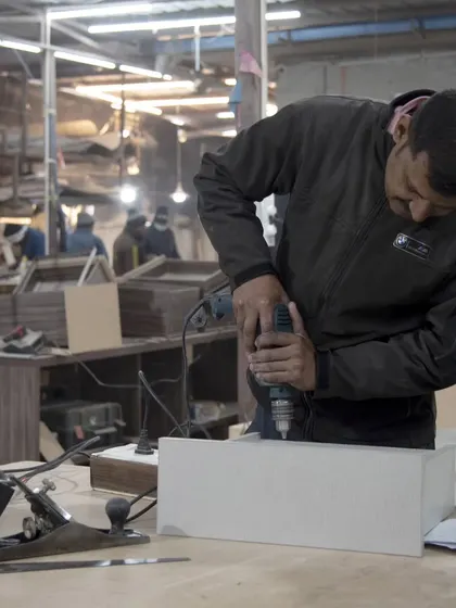 Our artisans are the silent storytellers behind each piece. This craftsman is drilling with focus and precision, a testament to the unwavering dedication that transforms raw materials into enduring beauty.