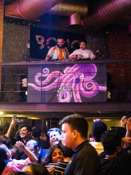 High above the crowd at BOHO, my partner and I orchestrate the night. We are committed to delivering the best Friday night vibes in town.
