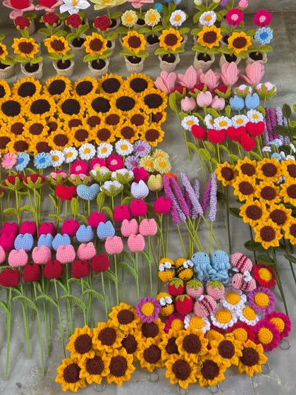Another angle of the floor filled with handmade flower stems, ready for packing.