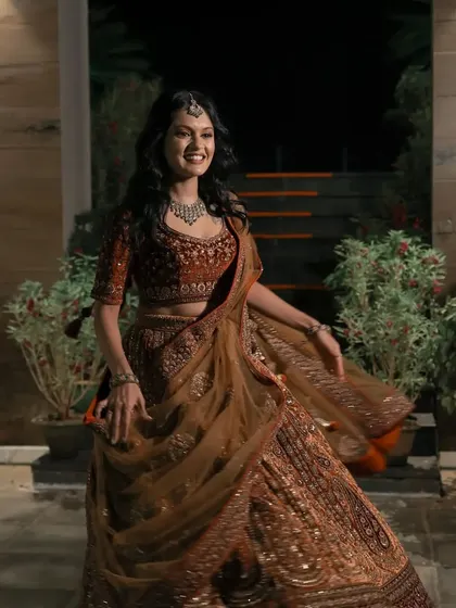 A joyful, twirling portrait of the bride from her engagement night. Her happy movement and the beautiful flow of her lehenga create a dynamic and celebratory image.