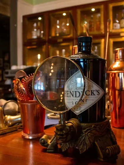 Details matter. A vintage-style magnifying glass rests on the bar, inviting you to take a closer look.