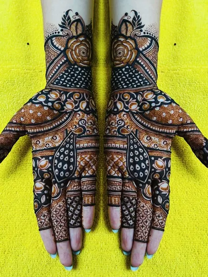 A beautiful floral design with peacock accents. This kind of intricate, full-hand design is perfect for any festive occasion.