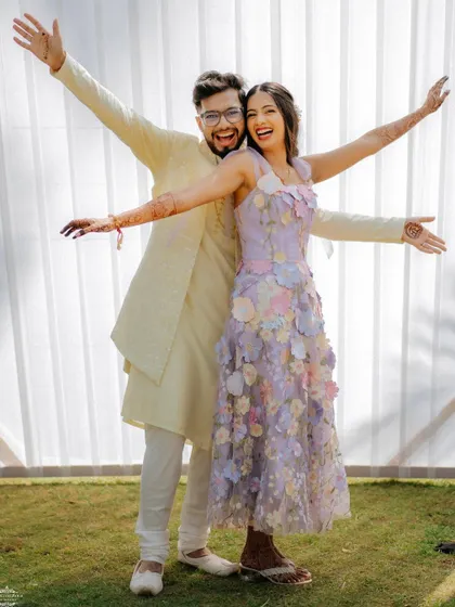 A playful pose from the couple, showing off their coordinated outfits and fun personalities.