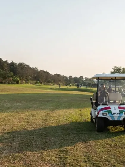 A golf cart parked on the course, ready for the next hole. It highlights the convenience we offer for navigating the greens while enjoying the wide-open spaces.