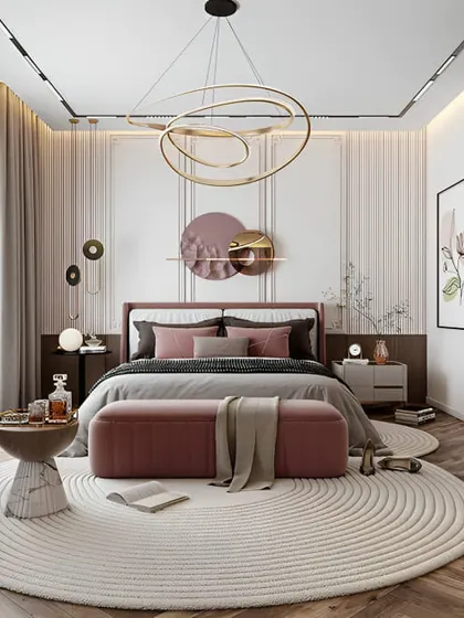 I love the soft, romantic feel of this bedroom. The circular rug, curved furniture, and beautiful pendant light create a harmonious and elegant space. The pink and grey color scheme is modern and chic.