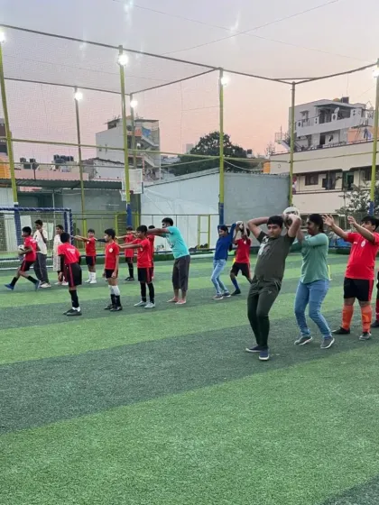 Parents and kids participating together in a fun throw-in drill at our Community Fest.