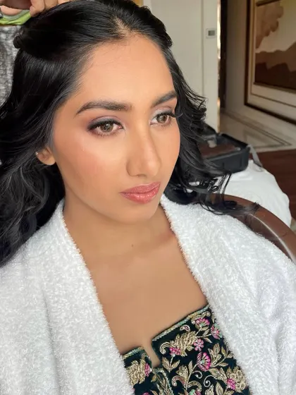 Another angle of the soft glam makeup in progress, showing the blended eyeshadow and defined brows.