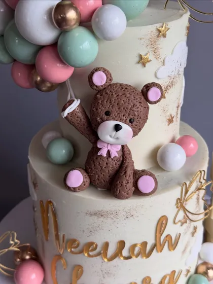 A close-up of the handcrafted teddy bear topper. I love creating these sweet characters to welcome the little ones.