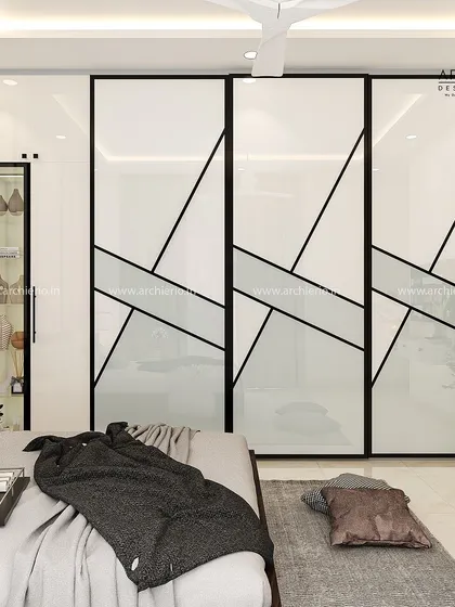 This bedroom features a striking wardrobe with geometric black-on-white patterns. The design is bold and modern, serving as a statement piece in the room.