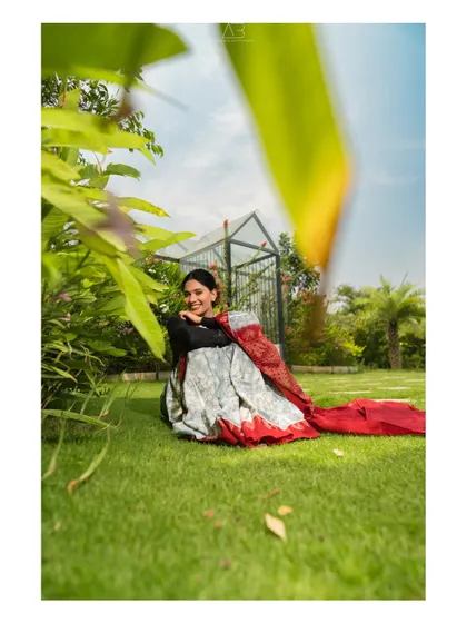 Another shot from the garden series, this one feels more intimate and candid. The natural smile and relaxed pose tell a story of comfort and timeless elegance.