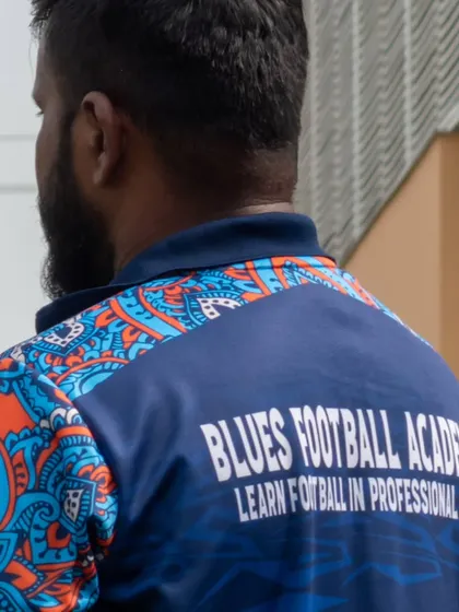 A shot of one of our coaches, whose jersey reads "Learn football in a professional way." This reflects the high standard of coaching and organization at our events.