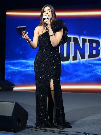 Holding an award, ready to announce the next winner at the Mankind Pharma event. Making these moments special is what I do best.