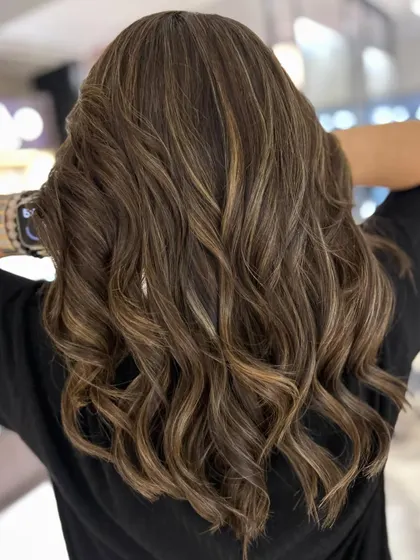 A beautiful warm-to-cool hair color change. I gave her a new textured haircut and added cool beige blonde highlights to create this fresh, updated style.