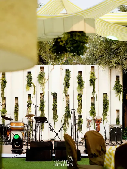 We created a stylish backdrop for the live band, featuring a white paneled wall with vertical niches filled with cascading greenery. This ensured even the entertainment area was beautifully integrated into the event's design.