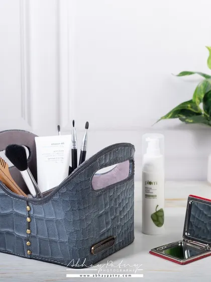 This lifestyle shot shows a leather organizer being used for beauty and grooming products. Demonstrating multiple uses for a product can significantly broaden its appeal to different customer segments.
