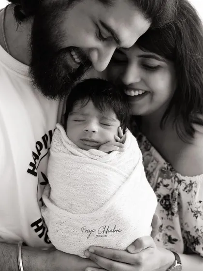 There's a special kind of magic in the first family portrait. This black and white image focuses on the pure joy and connection between new parents and their baby, a timeless memory of when your family grew.