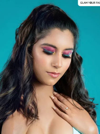 I love playing with color. This editorial look features a vibrant combination of pink shadow, a sharp blue winged liner, and a pop of yellow in the inner corner for a high-fashion, colorful statement.