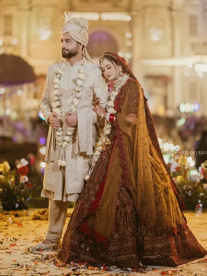 A romantic portrait of the couple, the bride resting her head on the groom's shoulder.