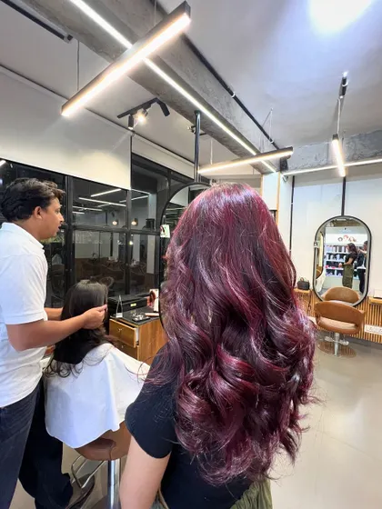 A gorgeous magenta hair color, achieved without using bleach. This shows that you can get vibrant results on dark hair with the right professional products.
