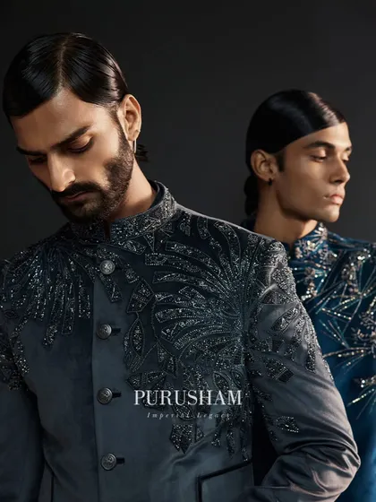 Where every stitch weaves a story of brilliance. The intricate, feather-like embroidery on this grey jacket is a hallmark of my craft, designed for a discerning eye.
