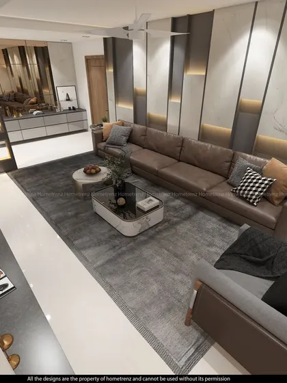 An overhead view of a spacious living room. The large leather sectional, plush area rug, and marble-topped coffee tables create a luxurious and comfortable gathering space.