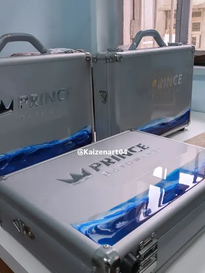 A shot of the completed briefcases for Prince Bathware. After a month of trial and error, we decided on this design which combines a transparent resin top half with an ocean-themed bottom half.