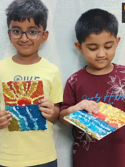 Two students showing their paper mache masterpieces. It's wonderful to see how each child interprets the same project in their own unique way.