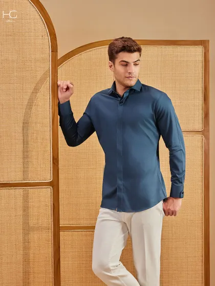 Clean contrast, crisp intent. This deep teal shirt paired with white trousers is where weekend ease meets weekday polish, offering a refined and simple look.