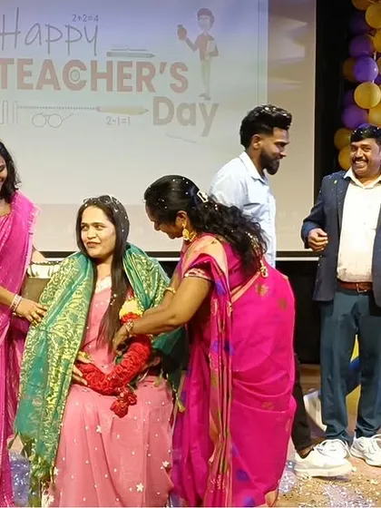 Another teacher is honored with a shawl and garland, a traditional gesture of respect and gratitude.