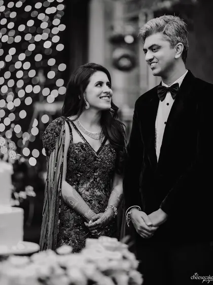 A beautiful candid of the couple listening to speeches, their expressions filled with love and gratitude.