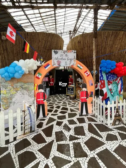 The adventure begins here. This entrance arch for a travel party is decorated with international flags and guarded by cutouts of the Queen's Guard.