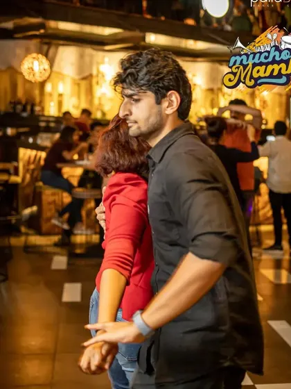 A close-up of two partners in a dance hold. This shows the fundamental connection and trust that is at the core of partner dancing.