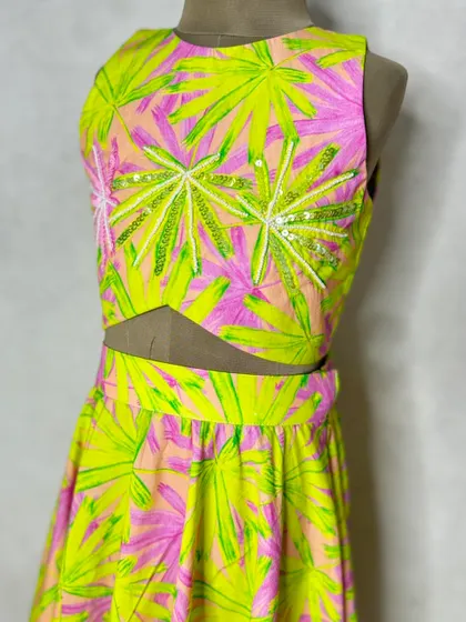 A close-up of the neon leaf print choli, showing the delicate sequin and thread embroidery that adds a touch of sparkle.
