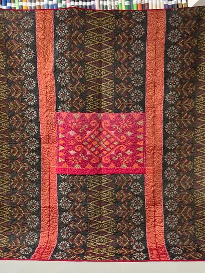 A collection of reversible memory quilts crafted from the sarees of a client's mother. Each side tells a different story, preserving the fabric's patterns and colors in a new, functional form.