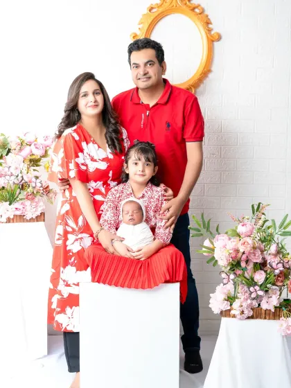 A complete family of four, celebrating the arrival of their newest member. This portrait beautifully documents this special chapter in their family's story.