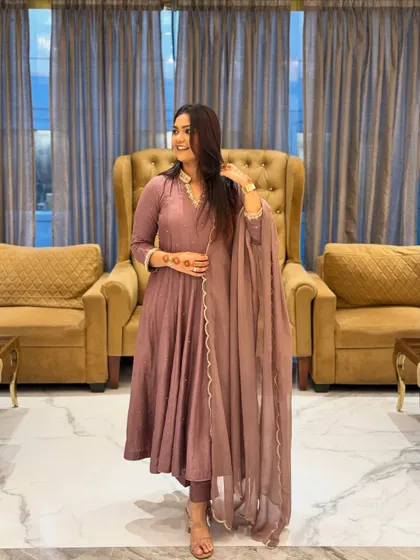 A candid shot in the mauve Anarkali. The A-line cut is flattering for many body types, creating a graceful, elongated look.