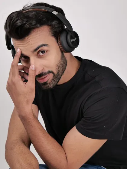 A model wearing headphones and looking at the camera. This engaging shot is great for website banners and social media, creating a connection with the viewer.