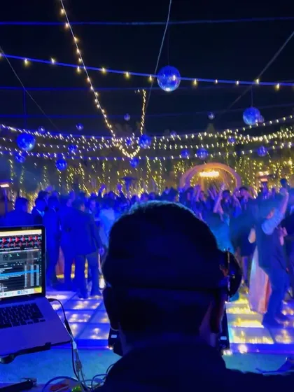 An outdoor sangeet under the stars in Rajkot. I specialize in creating the perfect soundtrack for weddings, blending Bollywood hits with crowd favorites to match the beautiful decor and celebratory mood.