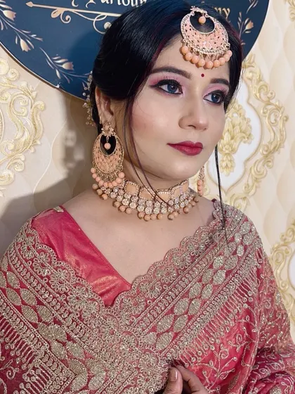 A client ready for a party with peach-toned makeup and matching jewellery.