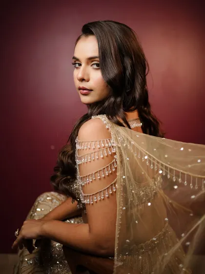 My golden girl! This look is perfect for a reception or cocktail party. The soft curls and glowing makeup complement the stunning gold outfit beautifully.