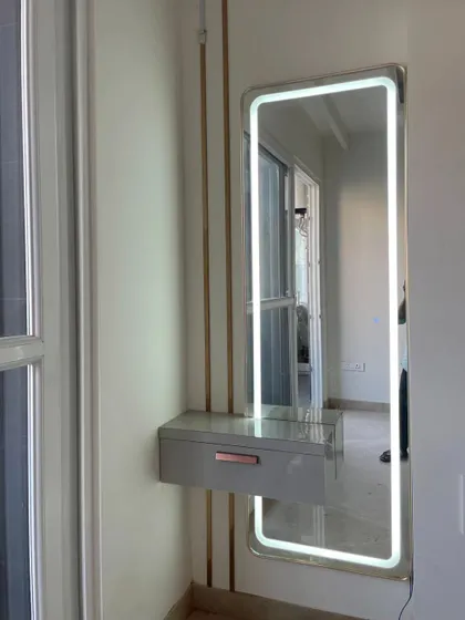 Another view of the wall-mounted dressing unit, showing its slim profile and modern aesthetic.