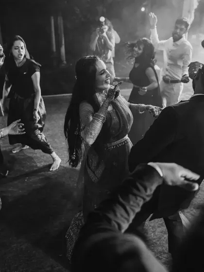 A candid, black and white shot of the couple enjoying a dance. These timeless photos capture the genuine love and happiness of the moment.