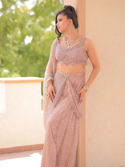 A full-length shot showing how the modern updo complements the contemporary design of her outfit. This is a perfect example of matching the hair to the overall vibe of the look.