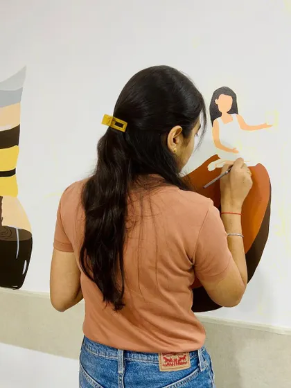 Carefully painting one of the characters relaxing on a giant coffee bean. Each character was designed to represent a relatable break-time moment.