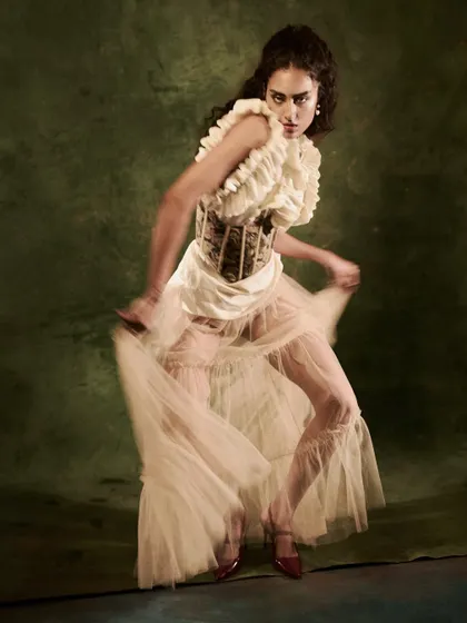 Capturing motion in the studio. A slightly slower shutter speed allows the tulle skirt to blur, conveying a sense of dance and movement, while a pop of flash freezes the model's expression.