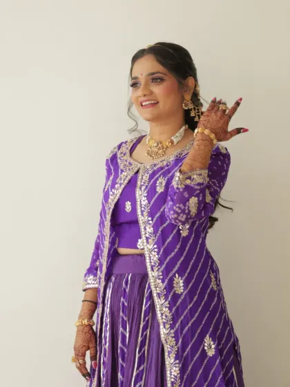 Posing for the camera. Her smile shows how confident and happy she feels.