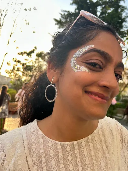 A beautiful smile framed by a sparkling silver crescent. It's wonderful to see adults embracing the fun of the glitter bar.