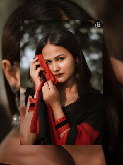 This close-up shot brings out the emotion in the model's eyes. The way she holds the saree's pallu adds a touch of shyness and traditional grace to the portrait.