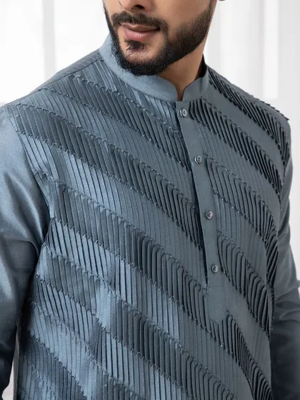 The texture of this deep grey kurta is its defining feature. The diagonal pintuck detailing creates a visually interesting and modern piece for evening events.