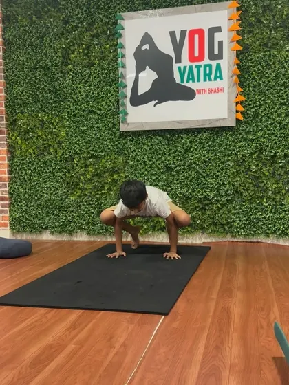 This student practices Bakasana (Crow Pose), building arm strength and concentration.